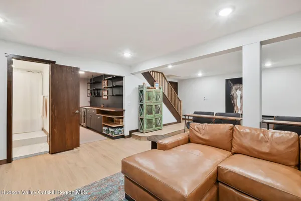a living room with furniture and floor to ceiling windows