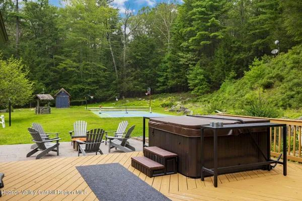 a view of a backyard with table and chairs and couches with wooden fence