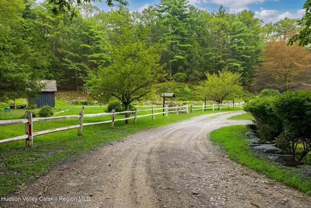 a living room with furniture and a kitchen