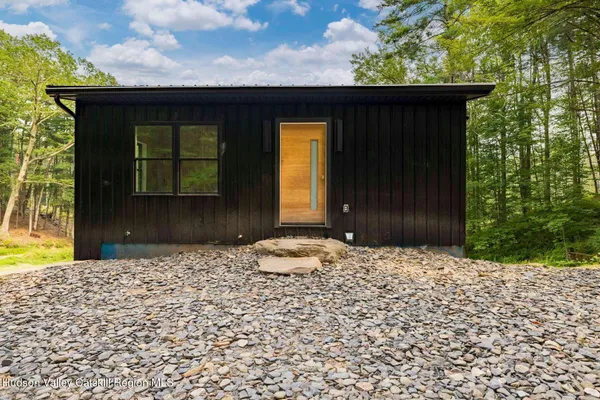 a view of a house with backyard porch and sitting area