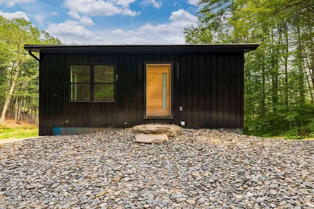a view of a house with backyard porch and sitting area