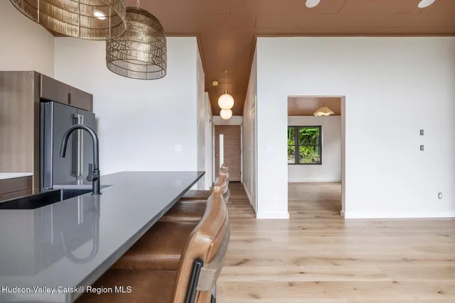 a view of a big yard with plants and large trees