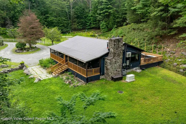 a backyard of a house with yard table and chairs