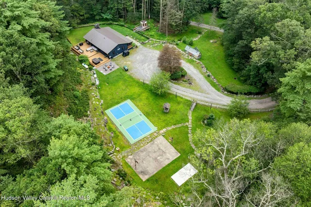a backyard of a house with yard table and chairs