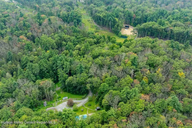 a backyard of a house with yard and outdoor seating