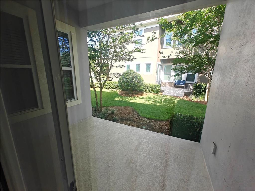 8075 Schelling Street Orlando, FL 32827 - Photo 13 of 51 a picture of a yard from a window