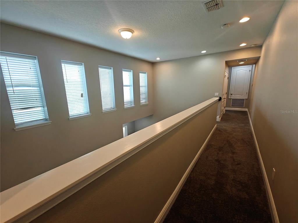 8075 Schelling Street Orlando, FL 32827 - Photo 22 of 51 a hallway with a large window