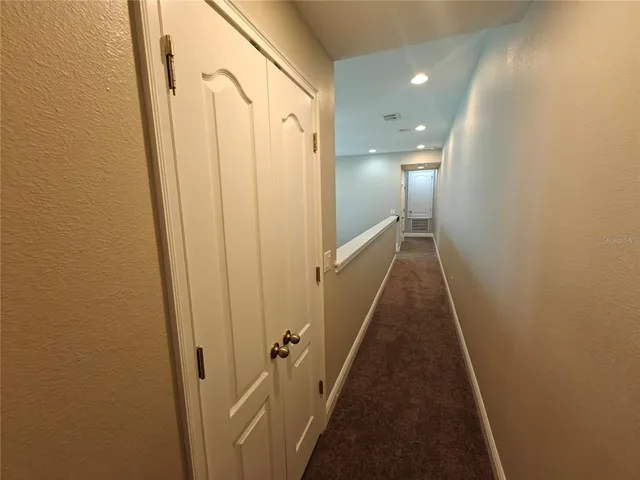 an empty room with windows and cabinet