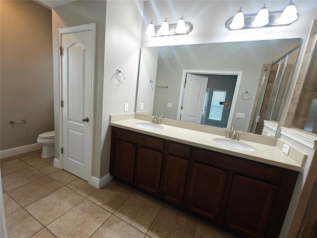 8075 Schelling Street Orlando, FL 32827 - Photo 27 of 51 a bathroom with a double vanity sink and a mirror