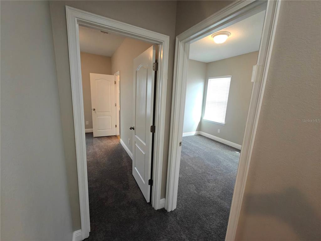 8075 Schelling Street Orlando, FL 32827 - Photo 34 of 51 a view of a bathroom from a hallway
