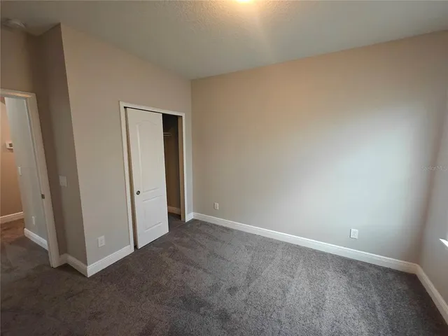 an empty room with sliding door and wooden floor
