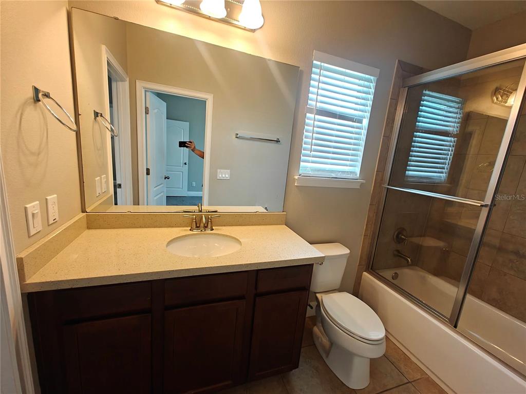8075 Schelling Street Orlando, FL 32827 - Photo 39 of 51 a bathroom with a sink and a mirror