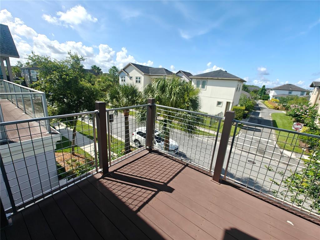 8075 Schelling Street Orlando, FL 32827 - Photo 45 of 51 a view of balcony with wooden floor and fence