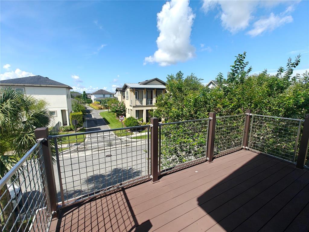 8075 Schelling Street Orlando, FL 32827 - Photo 47 of 51 a view of balcony with wooden floor and fence