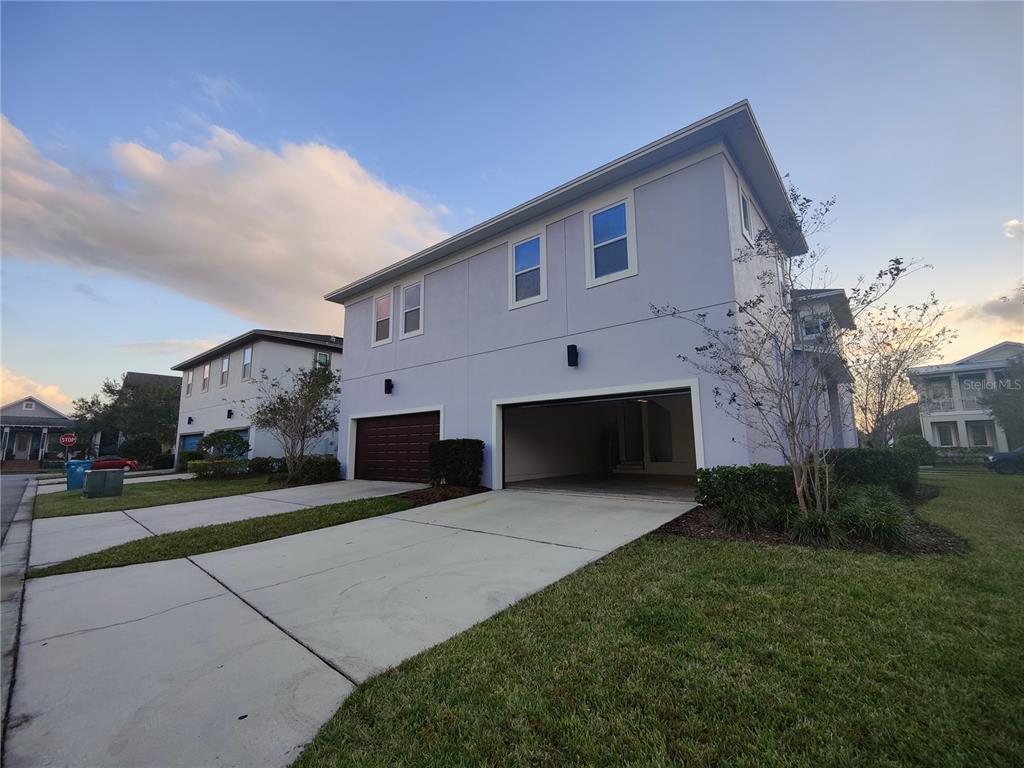 8075 Schelling Street Orlando, FL 32827 - Photo 49 of 51 a front view of house with yard and trees in the background