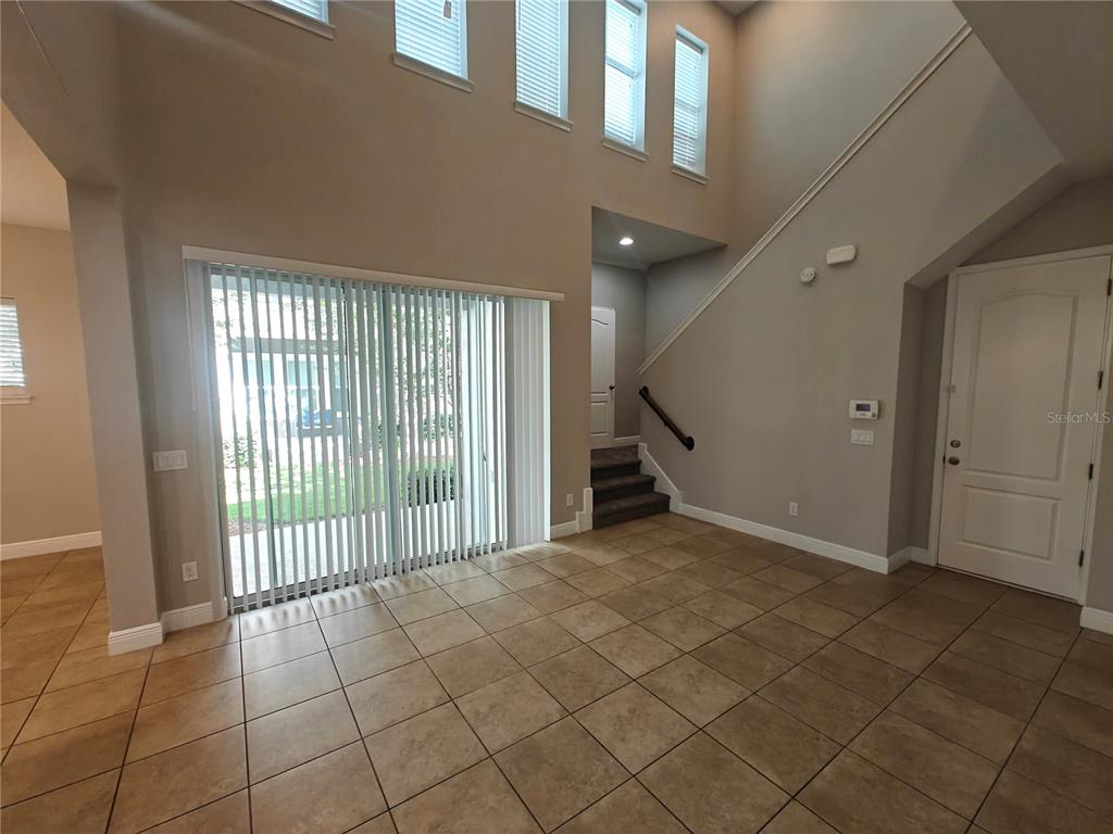 8075 Schelling Street Orlando, FL 32827 - Photo 9 of 51 a view of an entryway with staircase