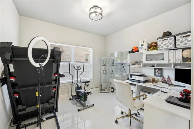 a view of a workspace with furniture and a fan