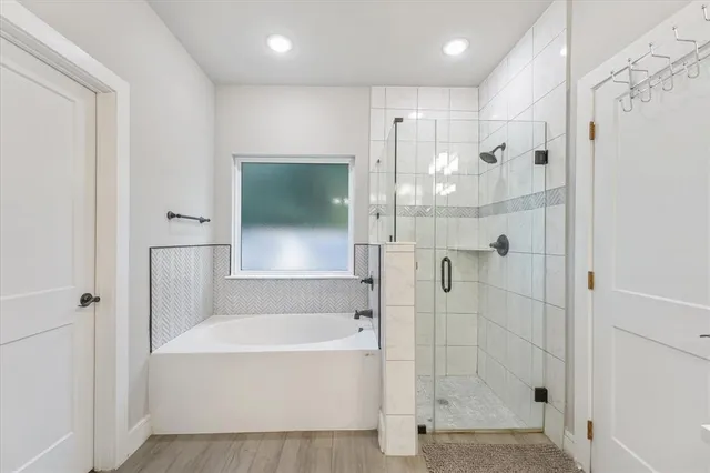 a bathroom with a bathtub and a shower