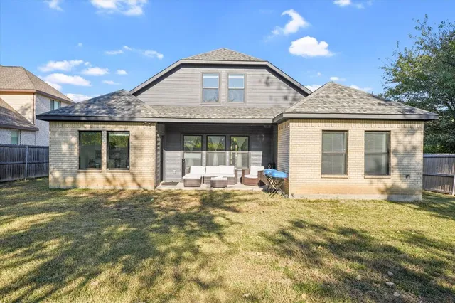 a front view of a house with a garden and yard