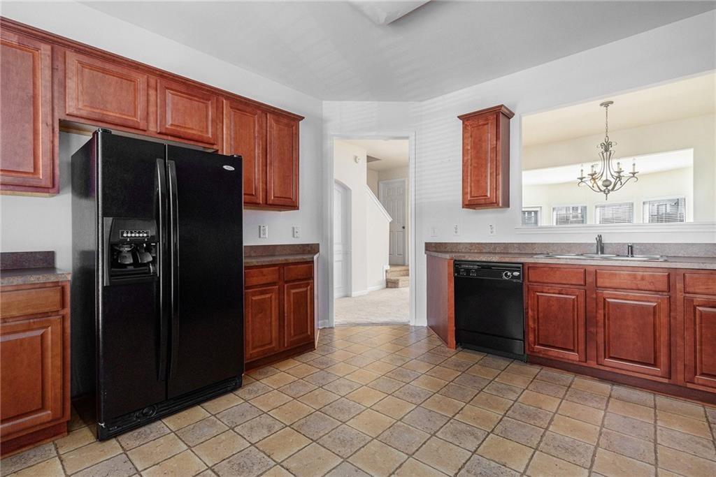 3656 Chicago Street Northwest Suwanee, GA 30024 - Photo 11 of 26 a kitchen with stainless steel appliances granite countertop a refrigerator and a sink