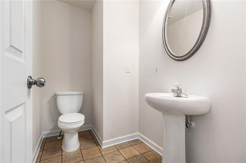 3656 Chicago Street Northwest Suwanee, GA 30024 - Photo 13 of 26 a bathroom with a sink toilet and a mirror