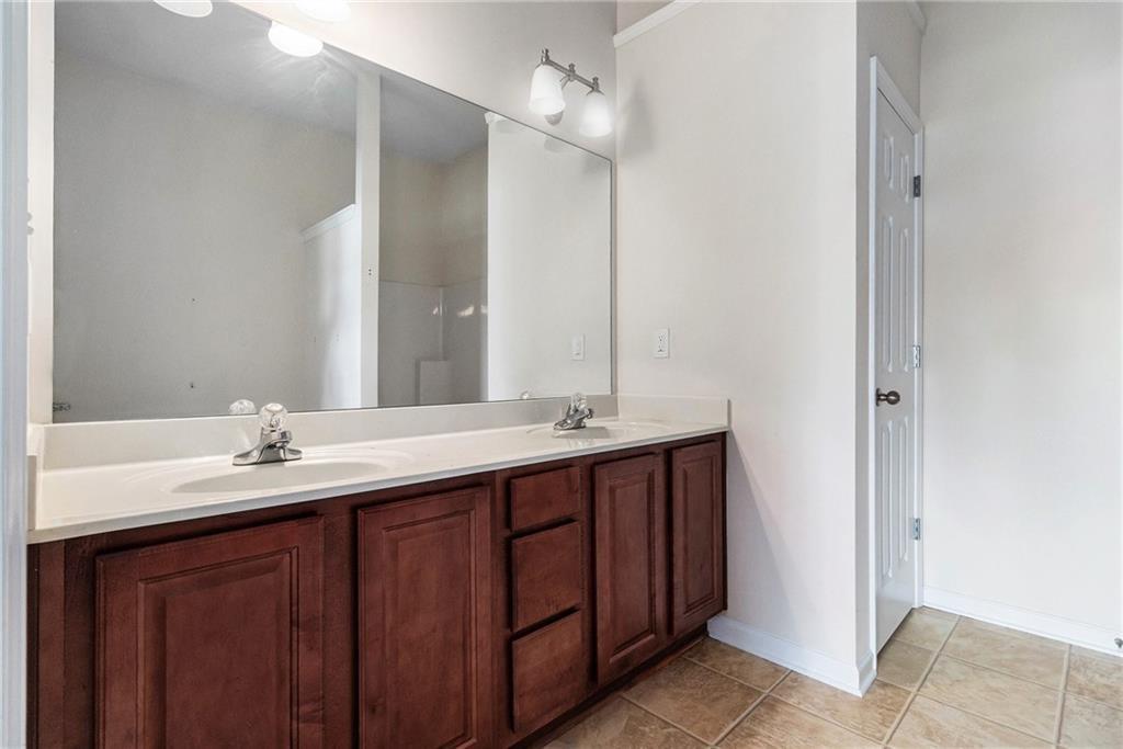 3656 Chicago Street Northwest Suwanee, GA 30024 - Photo 17 of 26 a bathroom with a double vanity sink and a mirror