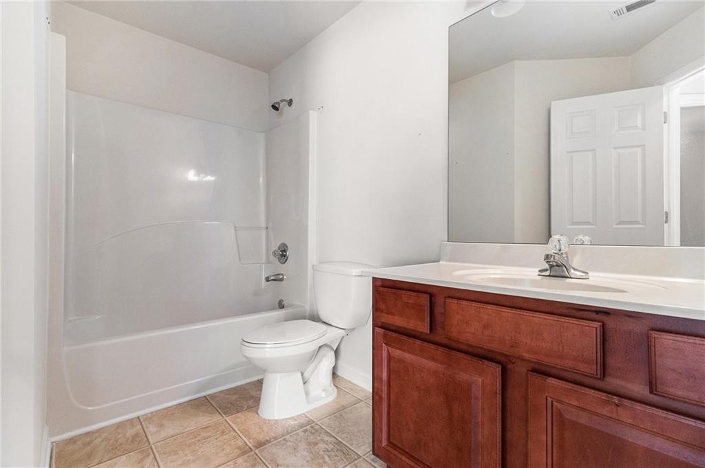 3656 Chicago Street Northwest Suwanee, GA 30024 - Photo 20 of 26 a bathroom with a sink a toilet and shower
