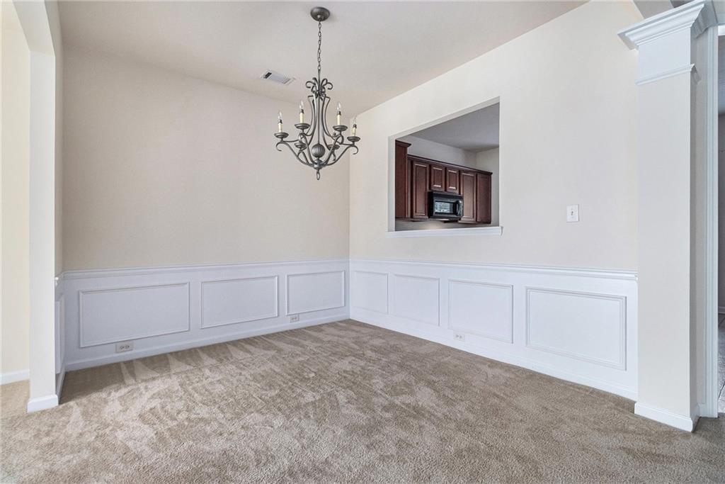 3656 Chicago Street Northwest Suwanee, GA 30024 - Photo 9 of 26 a view of a hallway with a chandelier