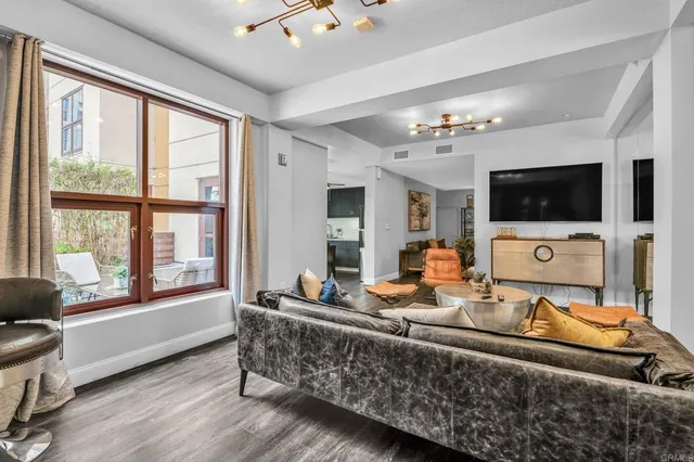 a living room with furniture and a potted plant