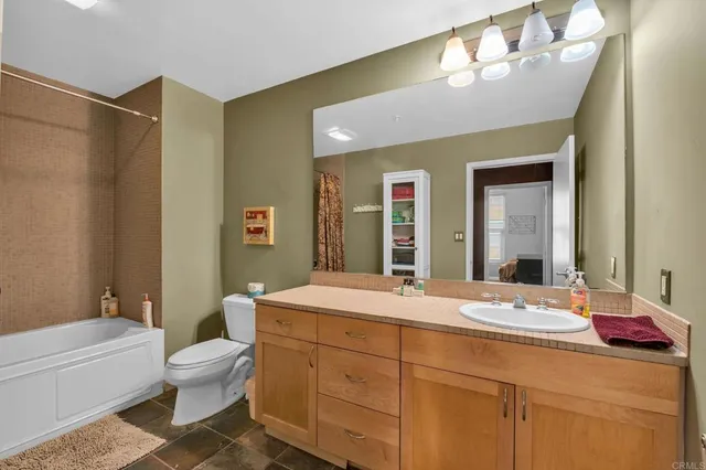 a bathroom with a double vanity sink mirror and toilet