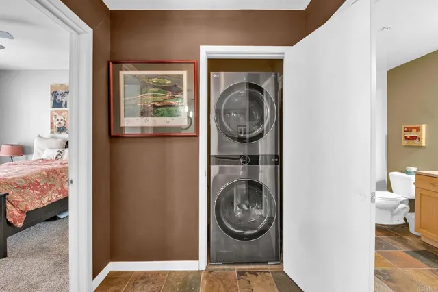 a view of a bedroom with washer and dryer
