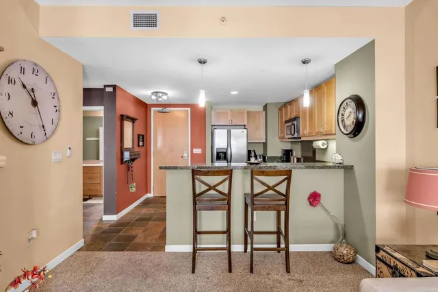 a view of kitchen with furniture and a refrigerator