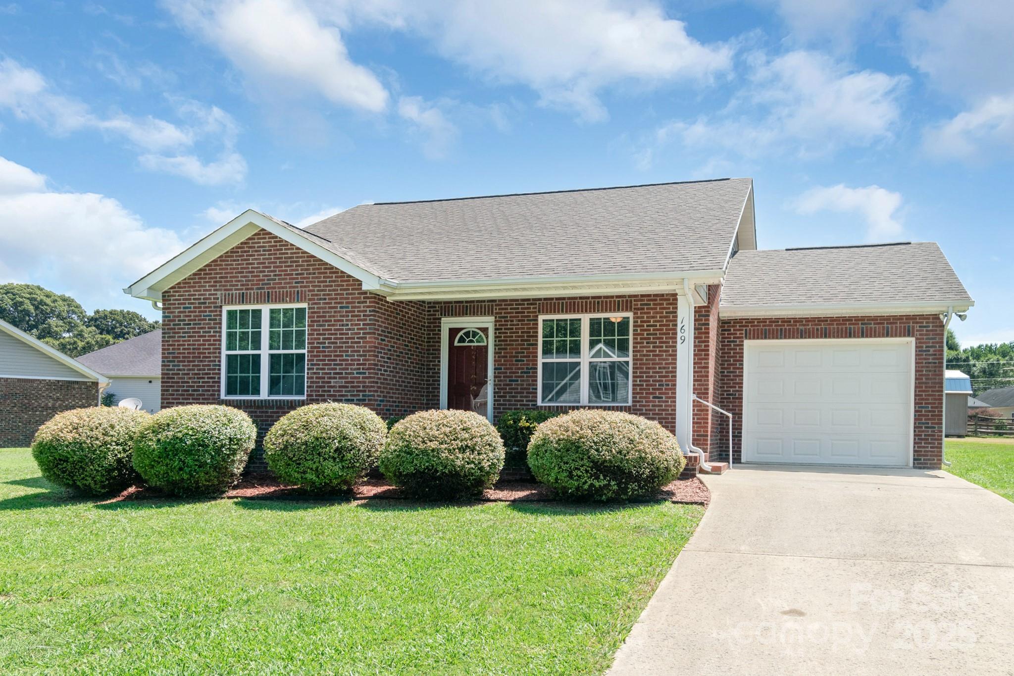 169 Abigail Lane Locust, NC 28097 - Photo 2 of 18 a front view of a house with garden