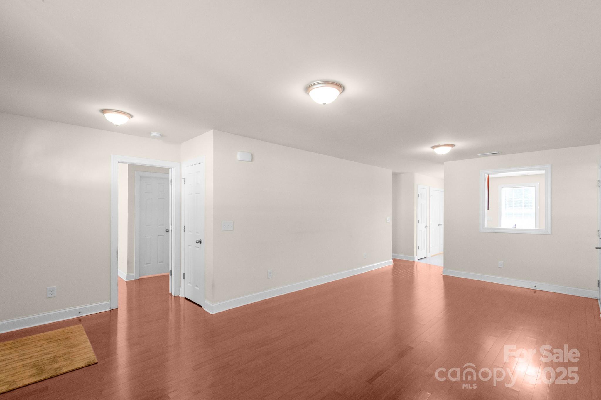 169 Abigail Lane Locust, NC 28097 - Photo 7 of 18 a view of an empty room with wooden floor and a window
