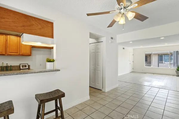a view of a livingroom with furniture and chandelier fan
