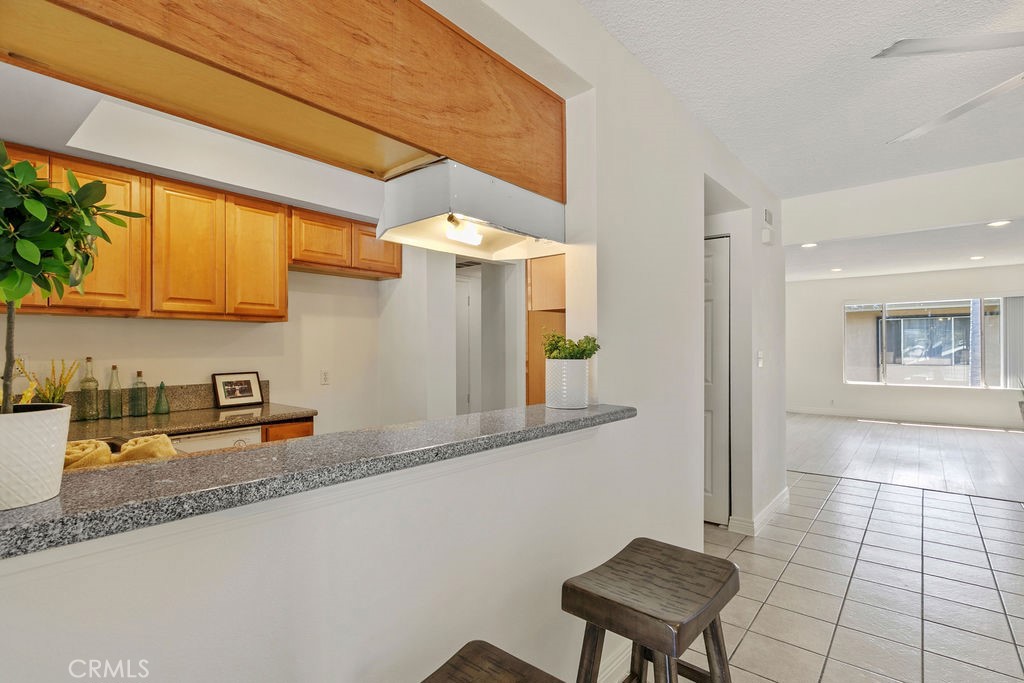 1801 Greenleaf Street, Unit 15 Santa Ana, CA 92706 - Photo 13 of 26 a kitchen with stainless steel appliances granite countertop a sink and a cabinets