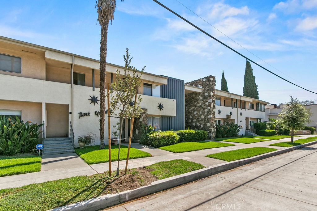 1801 Greenleaf Street, Unit 15 Santa Ana, CA 92706 - Photo 3 of 26 a view of a big building next to a yard