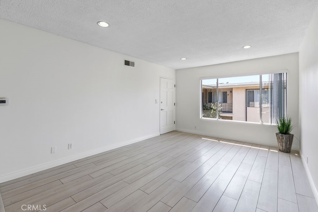 1801 Greenleaf Street, Unit 15 Santa Ana, CA 92706 - Photo 10 of 26 wooden floor in an empty room with a window