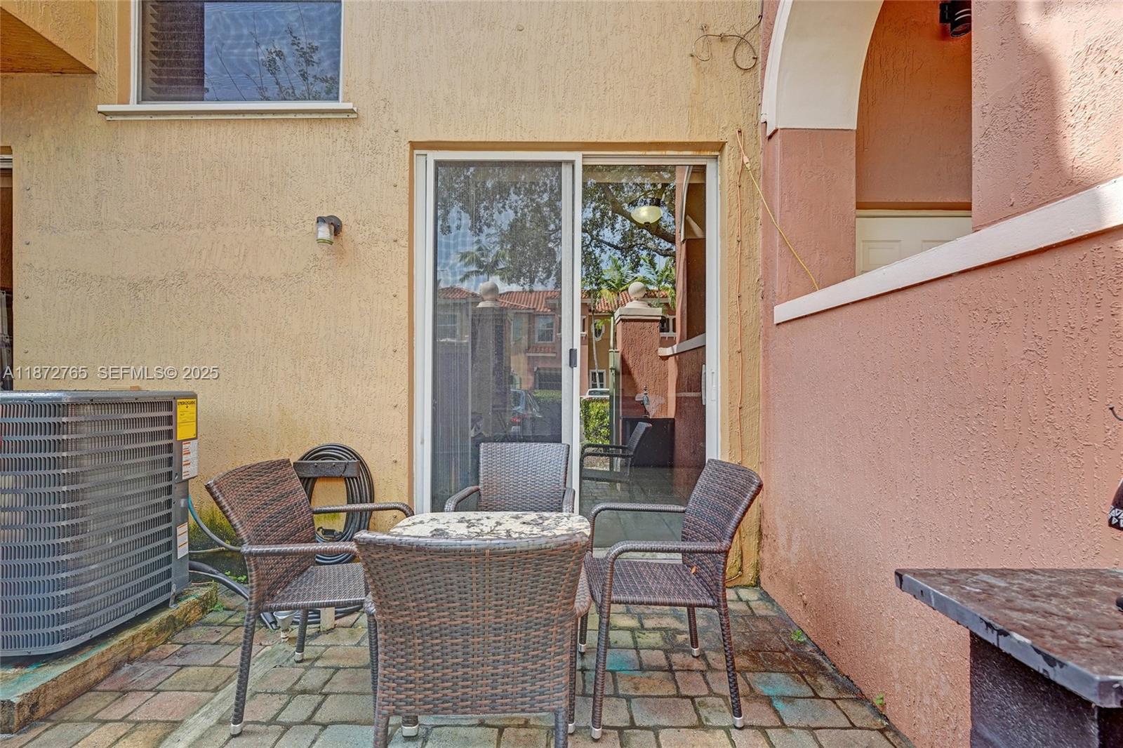 603 Southwest 107th Avenue, Unit 1701 Pembroke Pines, FL 33025 - Photo 11 of 41 a view of a dining room with furniture and window