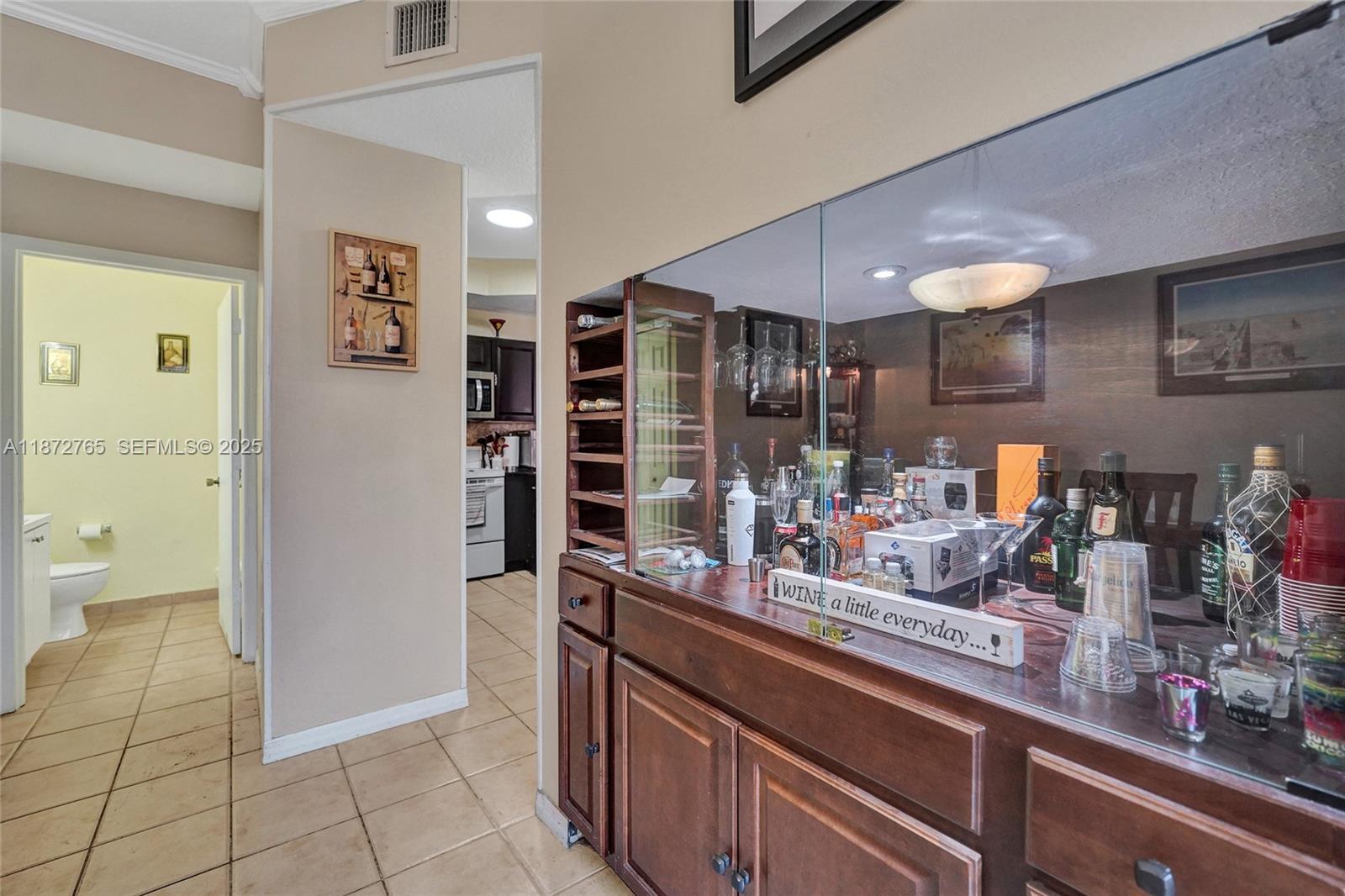 603 Southwest 107th Avenue, Unit 1701 Pembroke Pines, FL 33025 - Photo 14 of 41 a kitchen with stainless steel appliances kitchen island granite countertop a refrigerator and cabinets