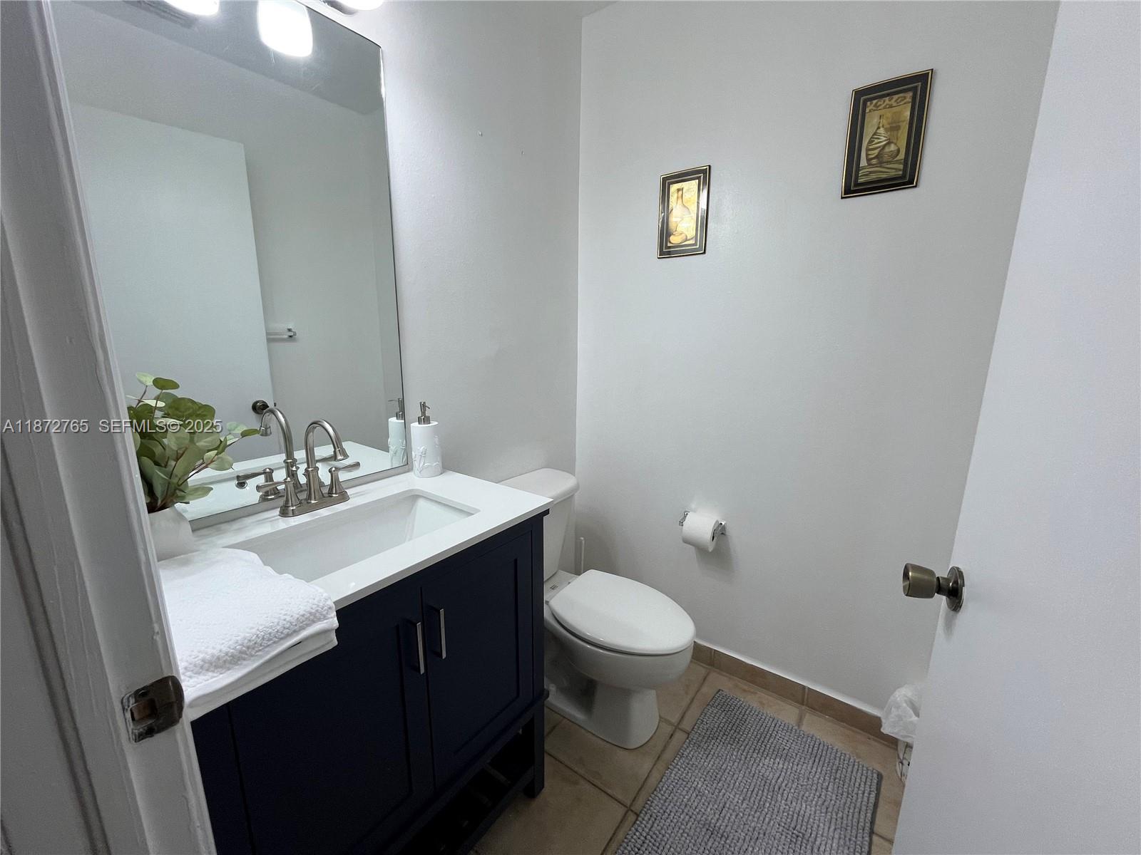 603 Southwest 107th Avenue, Unit 1701 Pembroke Pines, FL 33025 - Photo 16 of 41 a bathroom with a sink mirror and toilet