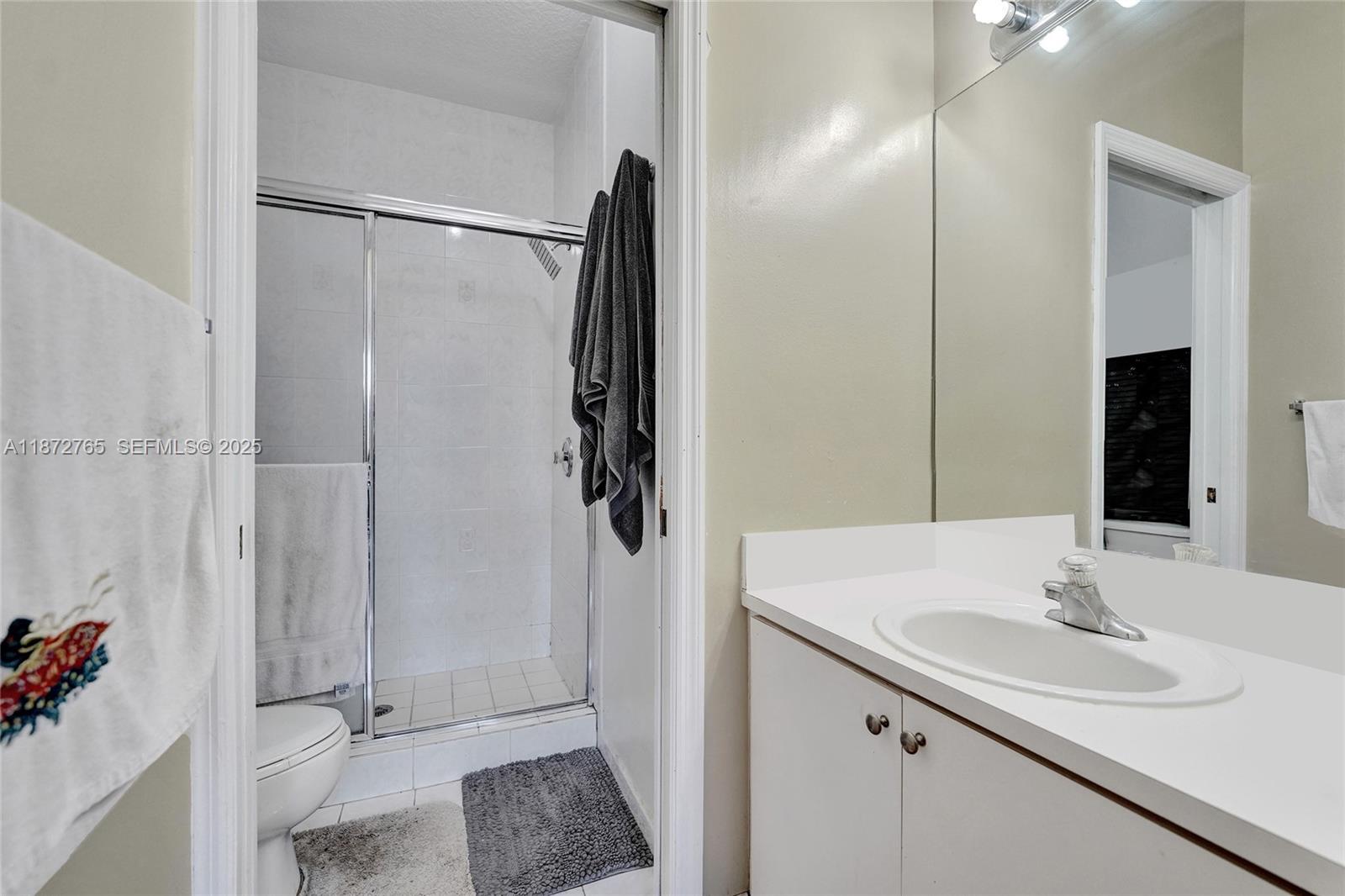 603 Southwest 107th Avenue, Unit 1701 Pembroke Pines, FL 33025 - Photo 20 of 41 a bathroom with a sink and mirror