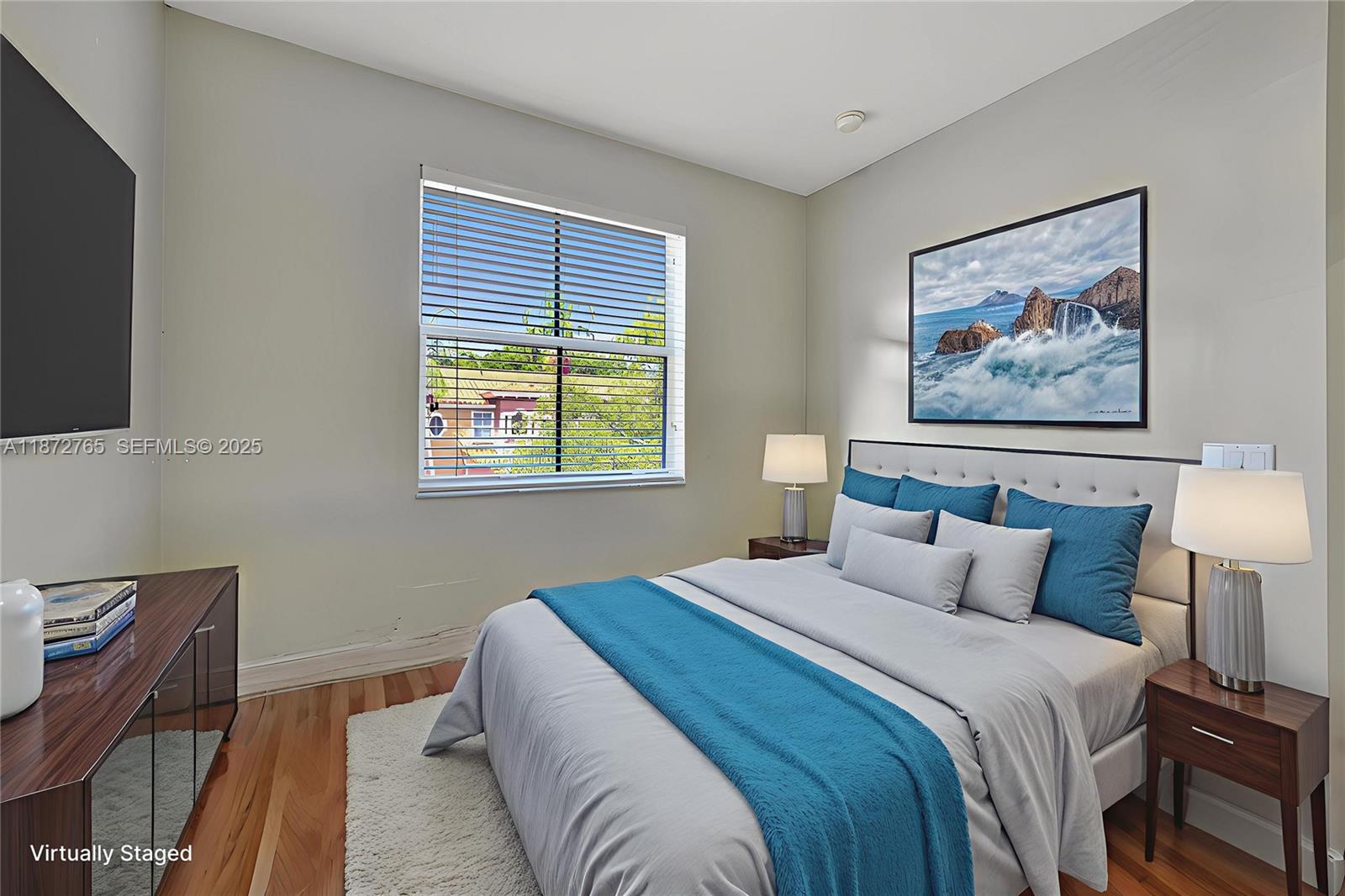 603 Southwest 107th Avenue, Unit 1701 Pembroke Pines, FL 33025 - Photo 21 of 41 a bedroom with a bed and a painting on the wall