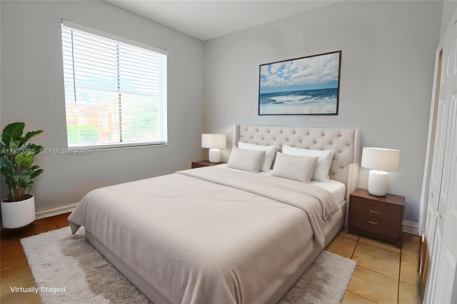 603 Southwest 107th Avenue, Unit 1701 Pembroke Pines, FL 33025 - Photo 22 of 41 a bedroom with a large bed and a potted plant