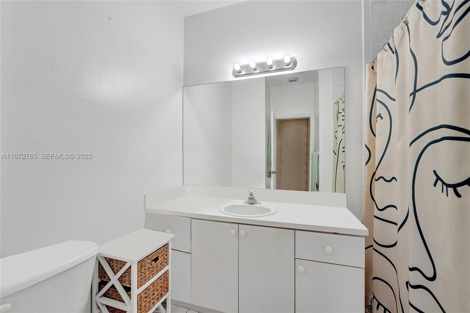 603 Southwest 107th Avenue, Unit 1701 Pembroke Pines, FL 33025 - Photo 23 of 41 a bathroom with a sink and mirror