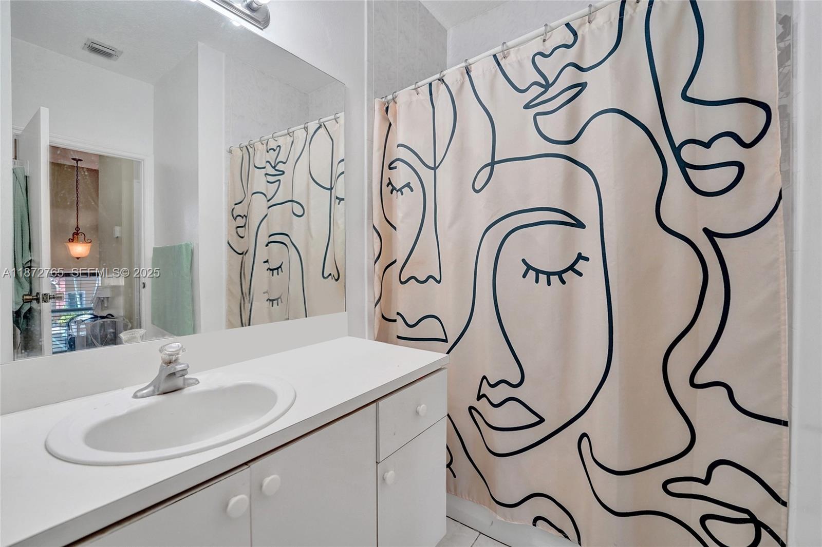 603 Southwest 107th Avenue, Unit 1701 Pembroke Pines, FL 33025 - Photo 24 of 41 a bathroom with a mirror and a sink