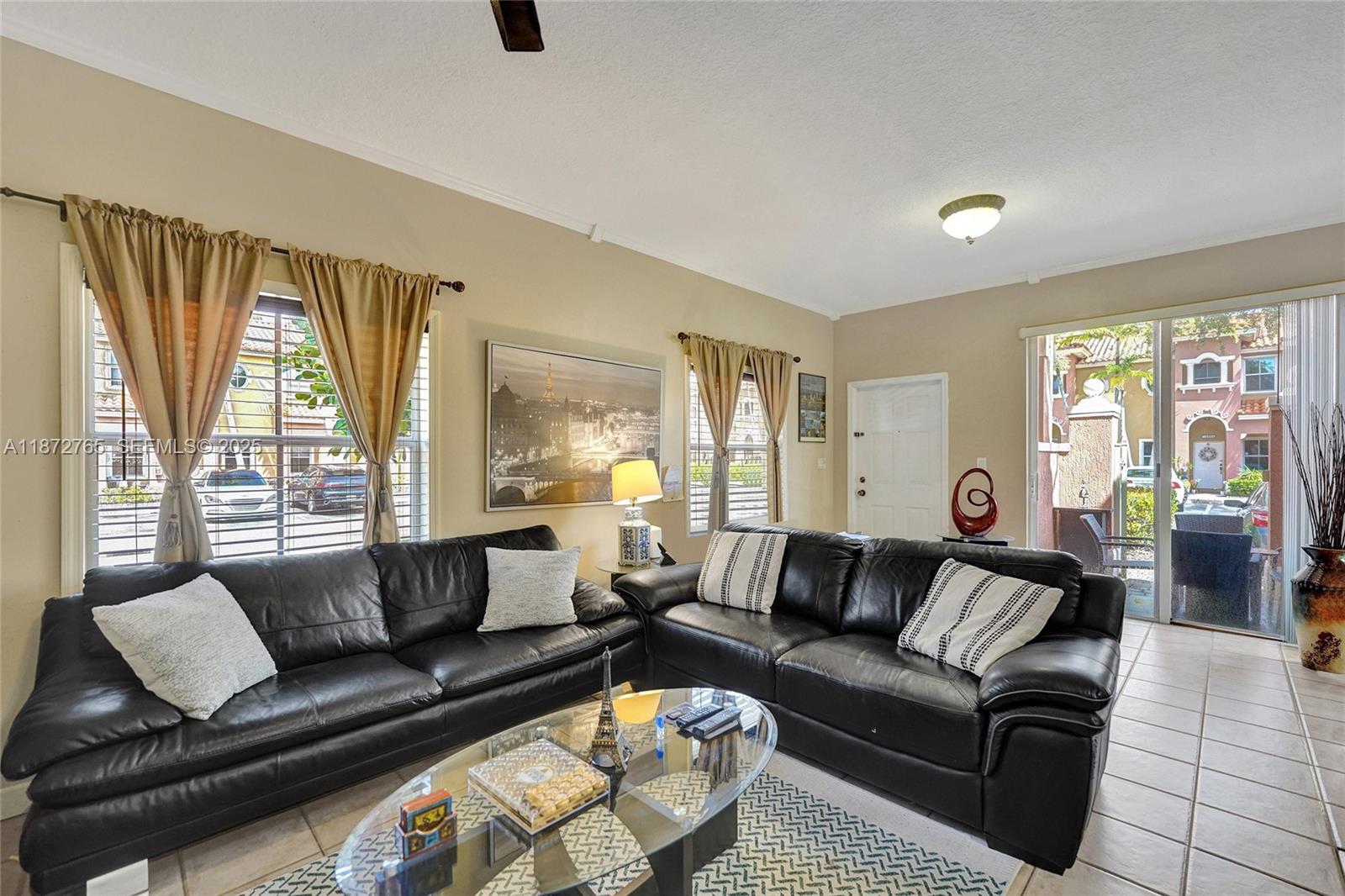 603 Southwest 107th Avenue, Unit 1701 Pembroke Pines, FL 33025 - Photo 28 of 41 a living room with furniture and a large window