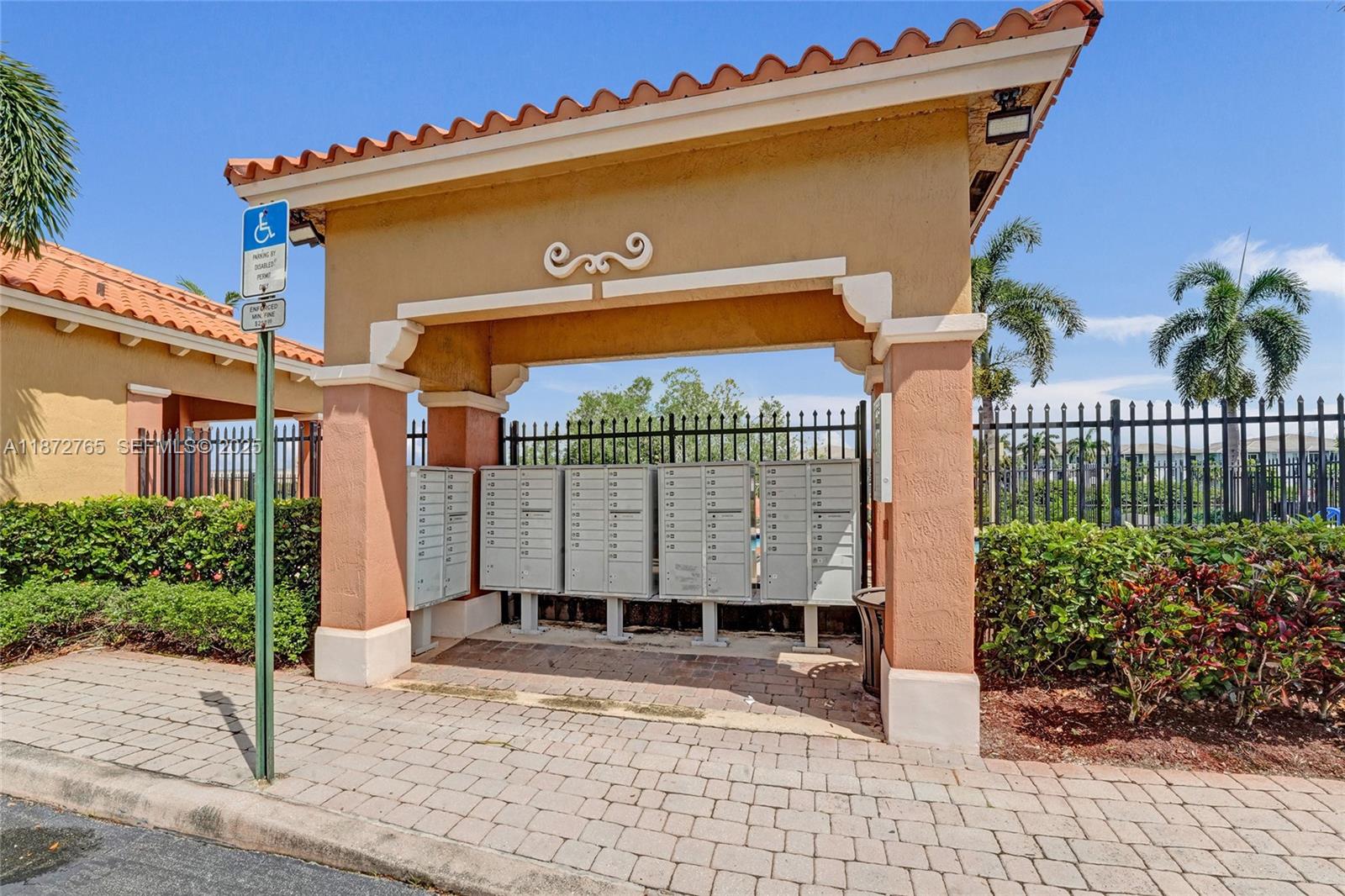 603 Southwest 107th Avenue, Unit 1701 Pembroke Pines, FL 33025 - Photo 36 of 41 a view of a house with a small yard and potted plants