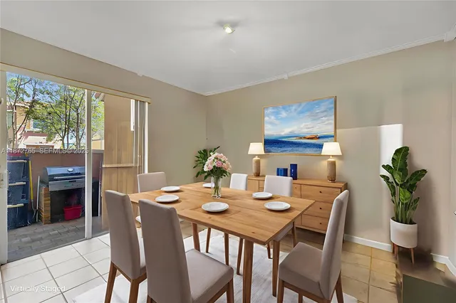 a living room with furniture and a view of kitchen