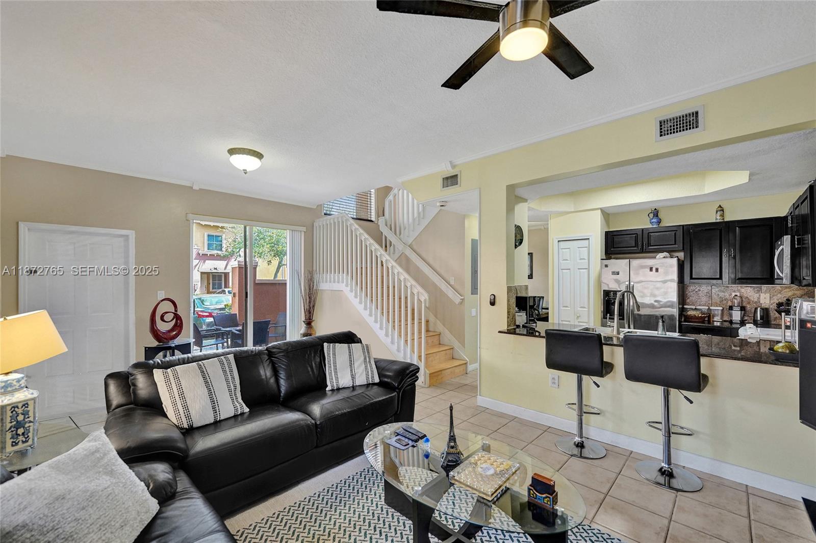 603 Southwest 107th Avenue, Unit 1701 Pembroke Pines, FL 33025 - Photo 6 of 41 a living room with furniture and a view of kitchen